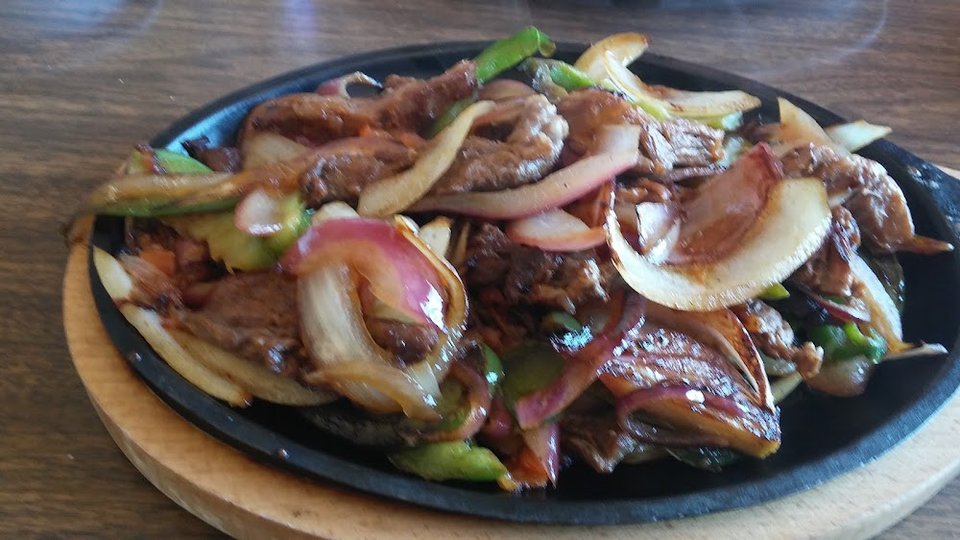 Printed menu with breakfast, fajitas, and soups.